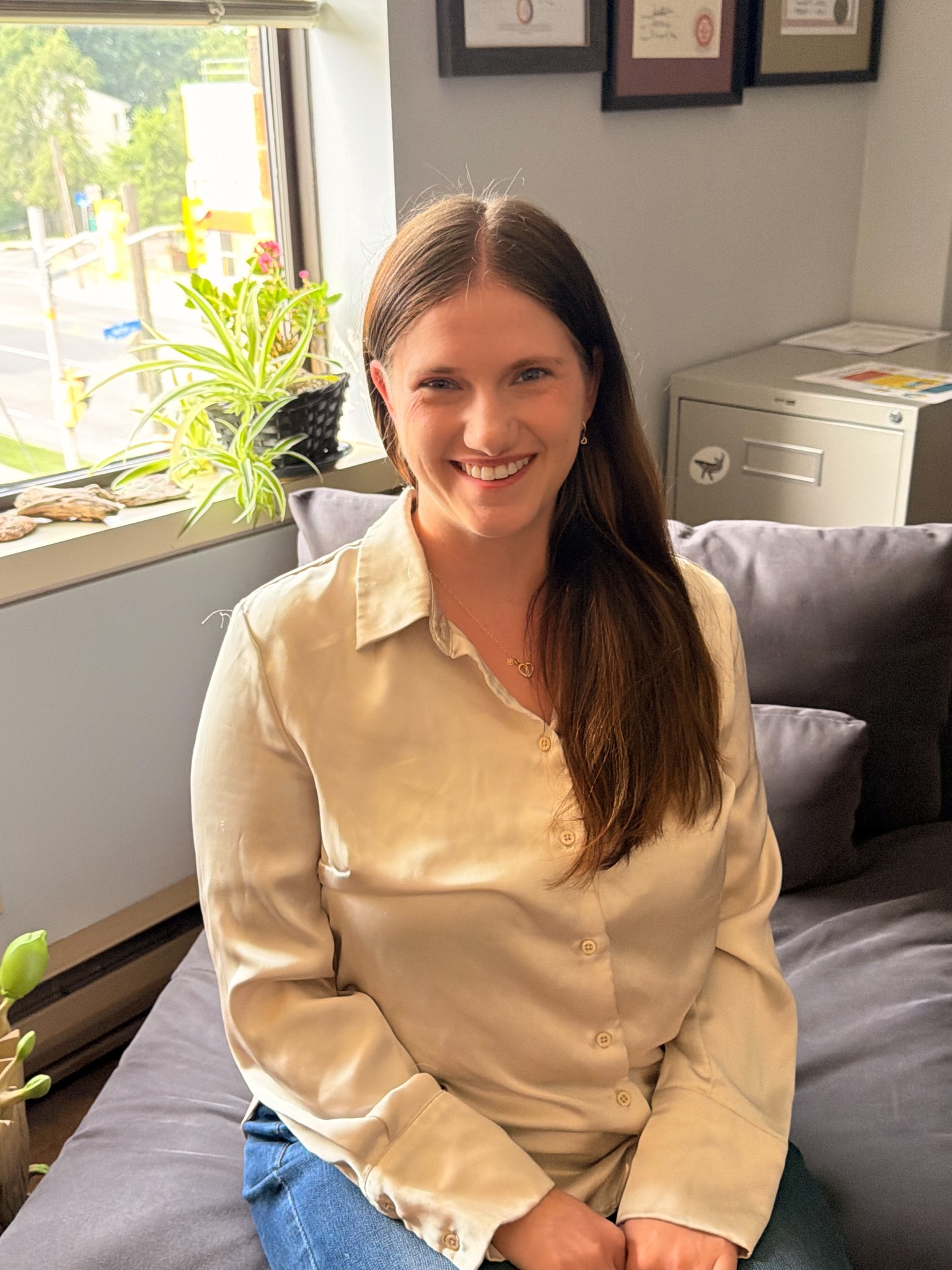 Melissa Dunn smiling in a therapy office