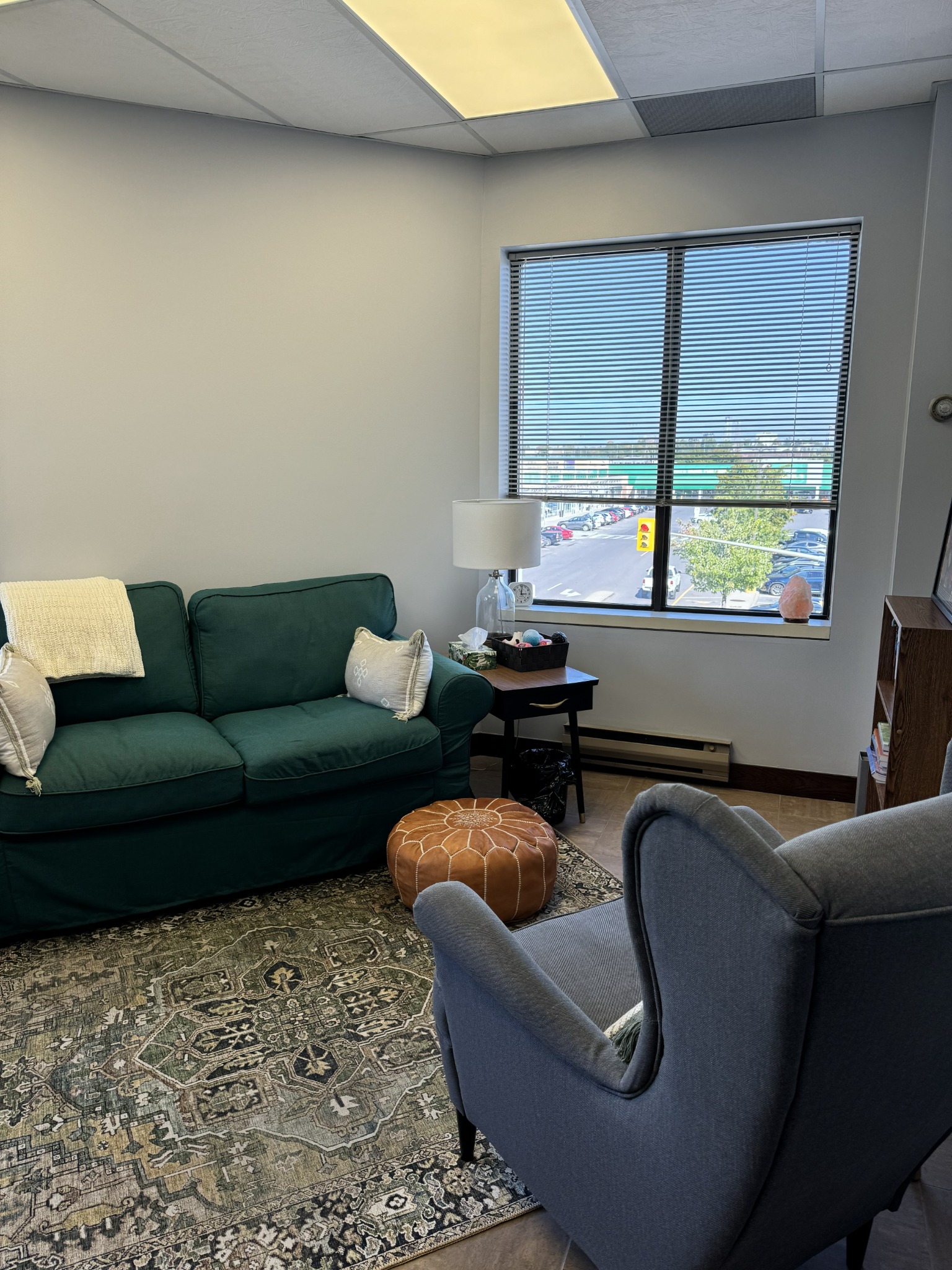 Therapy room with a green sofa and natural light