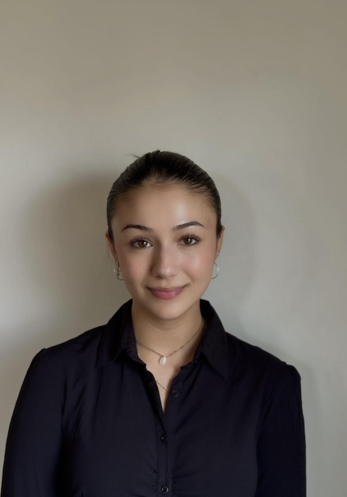 Renee De Wit smiling against a neutral background