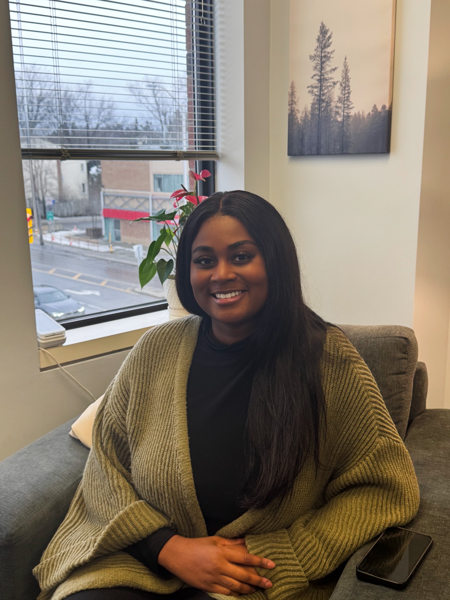 Tywanna Baptiste smiling in a green cardigan